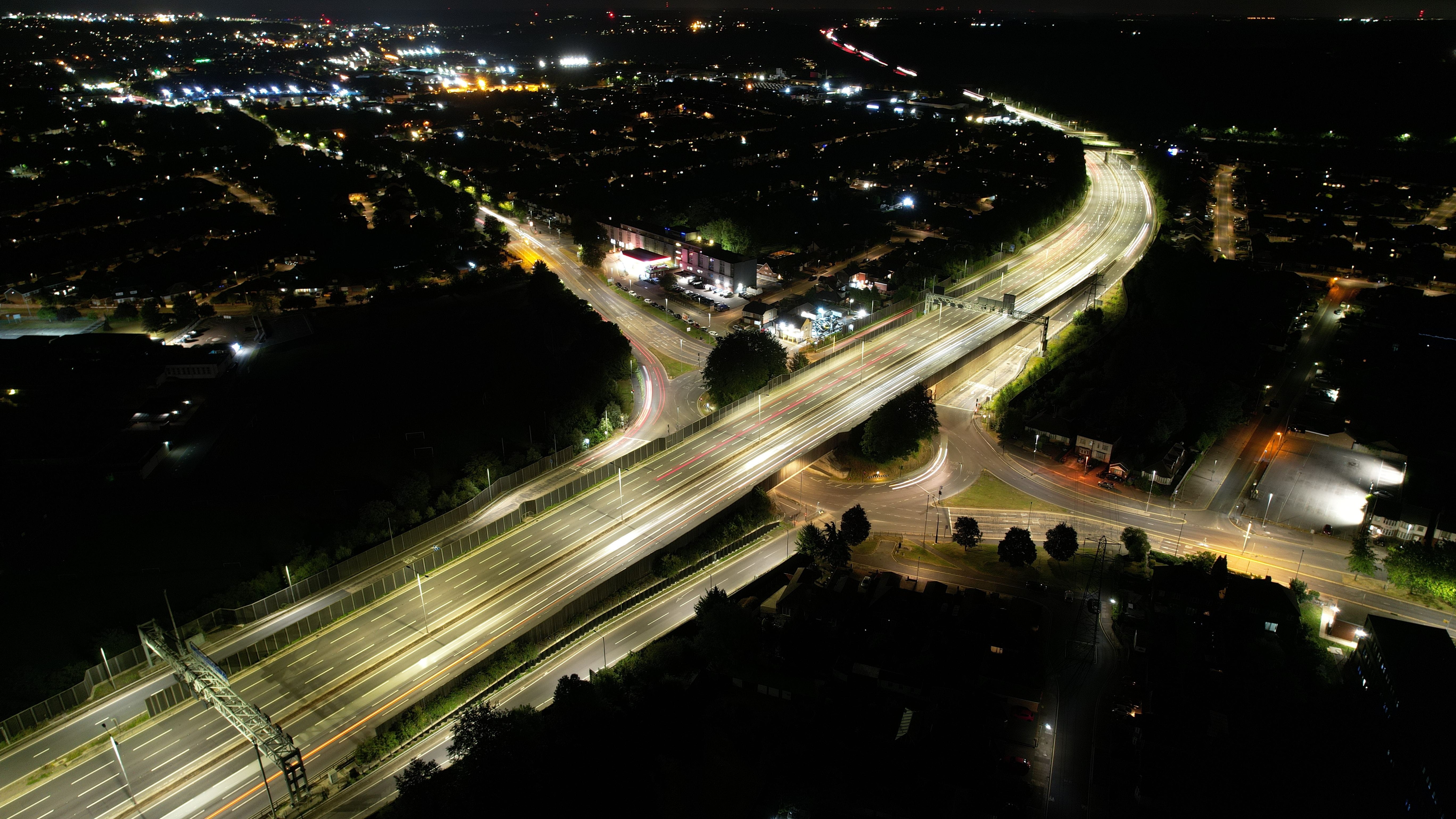 Night-time view of Luton town centre with illuminated roads and buildings, used to illustrate crime in Luton.