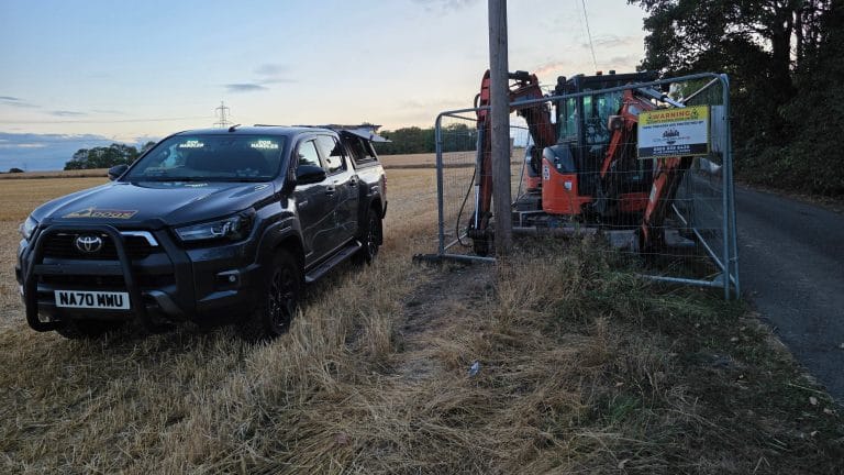 Civil engineering site security in Selby with Colosseum K9 vehicle beside fenced plant machinery.