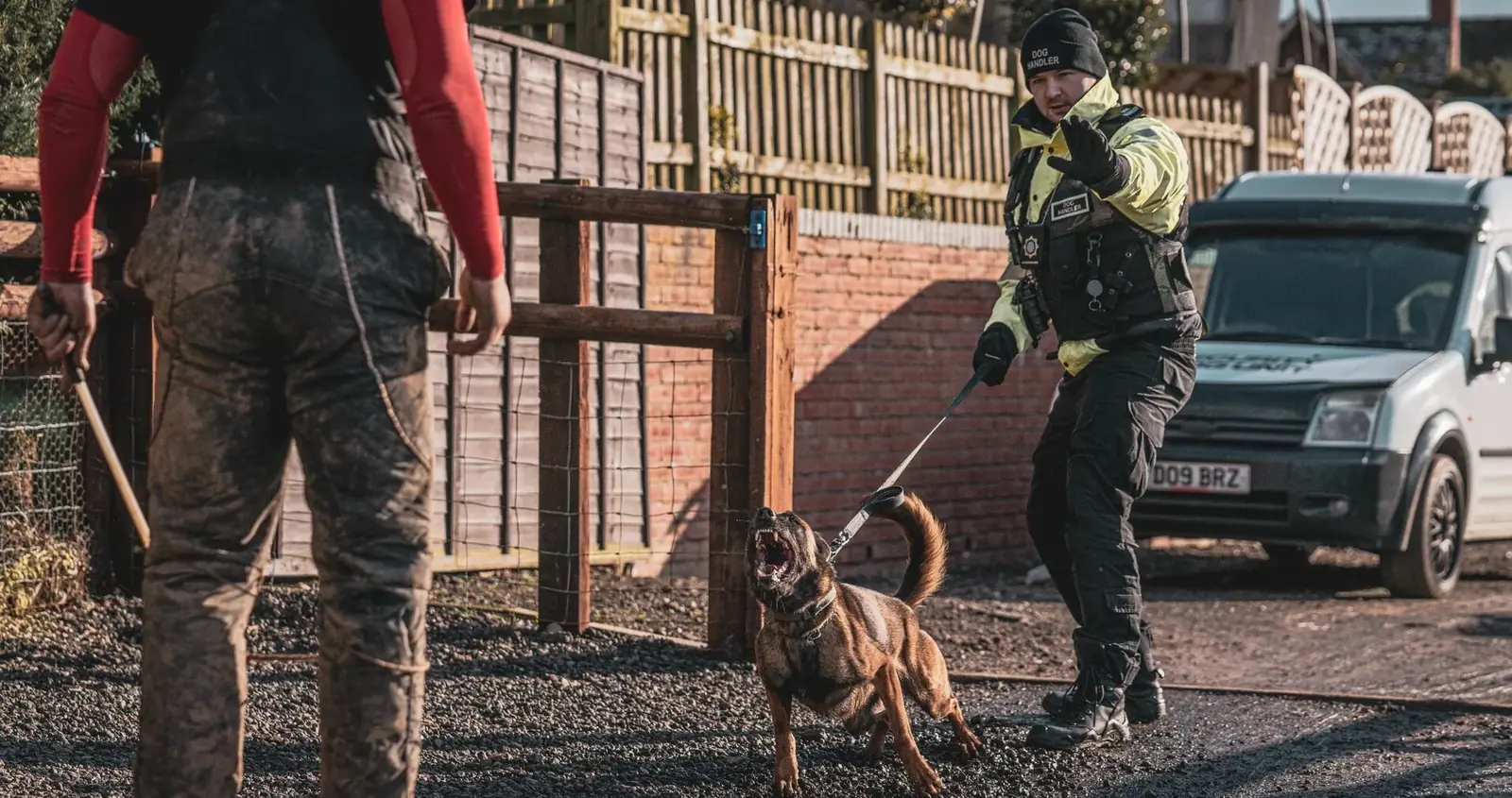 Security dog handler services in action, with a trained security dog and professional handler responding to a potential site threat.