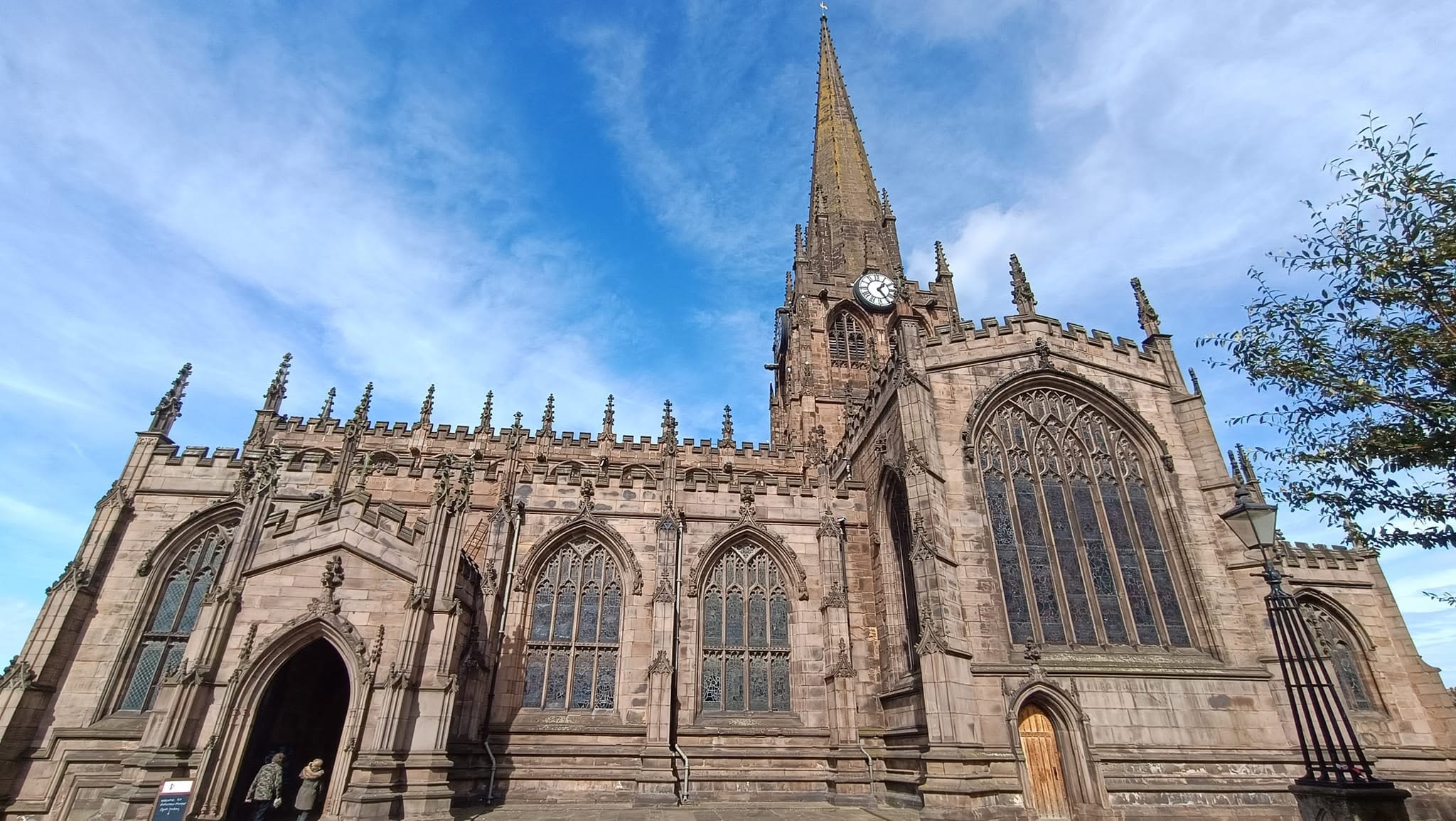 Crime in Rotherham: Rotherham Minster and its clock tower beneath a blue sky.